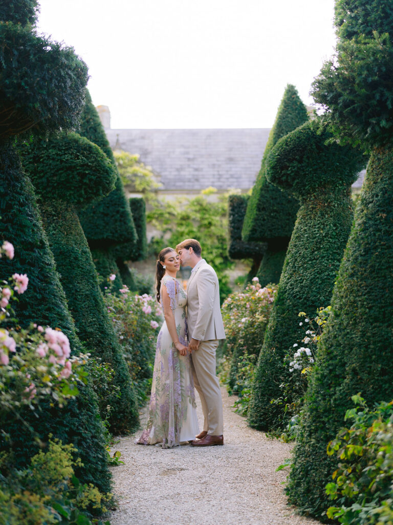 Euridge Manor Wedding Photographer couple portraits in rose garden kissing